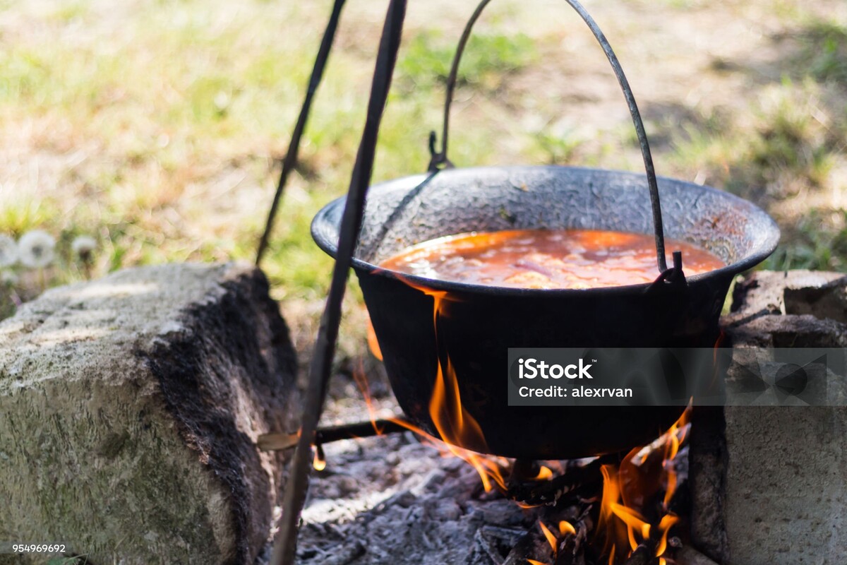 Gulyas stew boiling in a cauldron